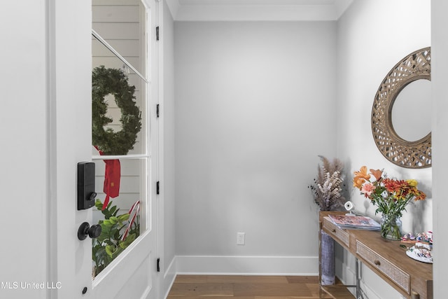 corridor with hardwood / wood-style flooring