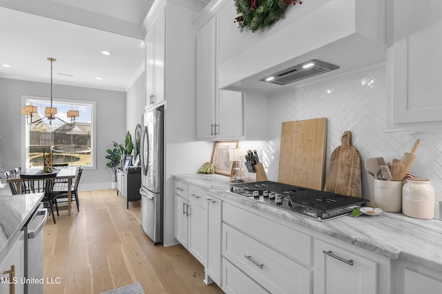 kitchen with white cabinetry, decorative backsplash, stainless steel appliances, and light stone counters