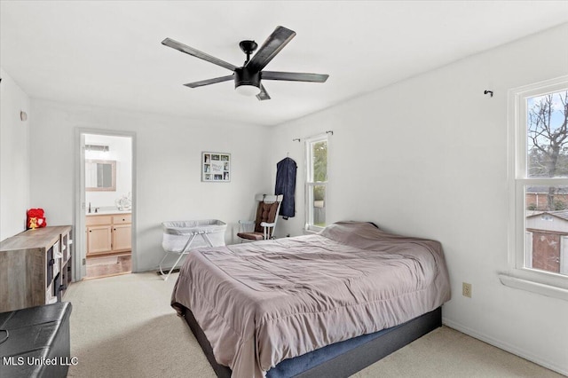 carpeted bedroom with ceiling fan and connected bathroom