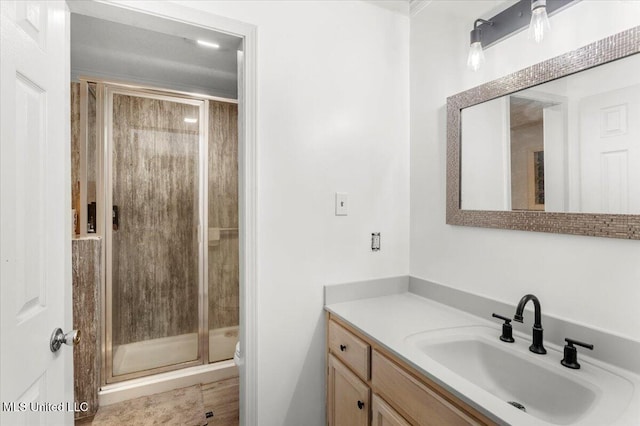 bathroom with a shower with shower door, toilet, and vanity