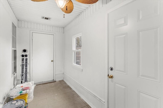 entryway with ceiling fan and light tile patterned floors