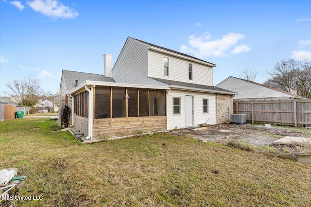 back of house featuring a lawn, cooling unit, and a sunroom