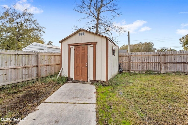 view of outbuilding with a yard