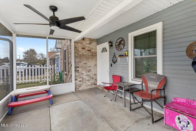 sunroom / solarium featuring ceiling fan