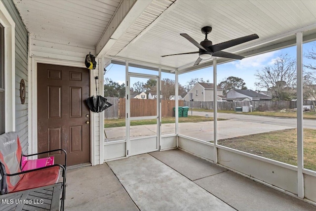 unfurnished sunroom featuring ceiling fan