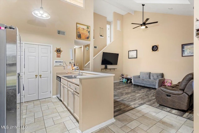 kitchen with ceiling fan, stainless steel appliances, beamed ceiling, high vaulted ceiling, and sink