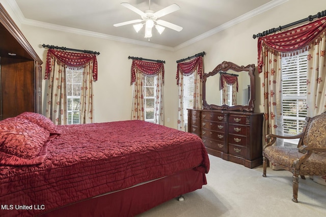 bedroom with crown molding, ceiling fan, and carpet flooring