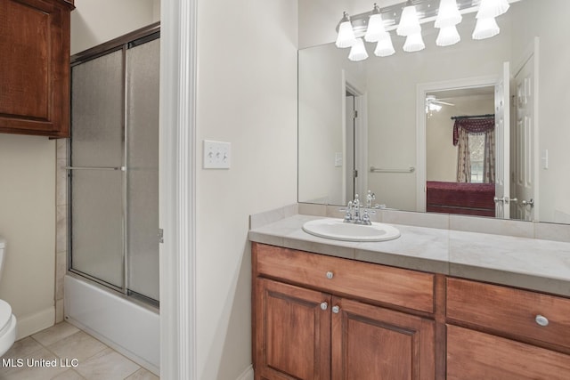 full bathroom featuring vanity, tile patterned floors, toilet, and combined bath / shower with glass door