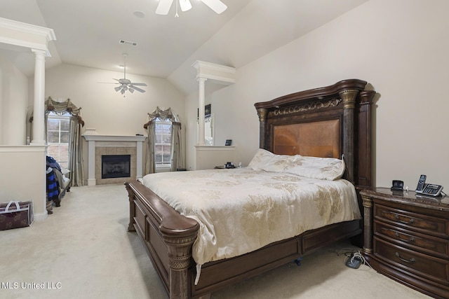 carpeted bedroom featuring ornate columns, ceiling fan, lofted ceiling, and a fireplace