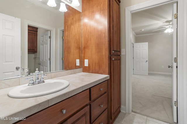 bathroom with crown molding, ceiling fan, vanity, and tile patterned floors