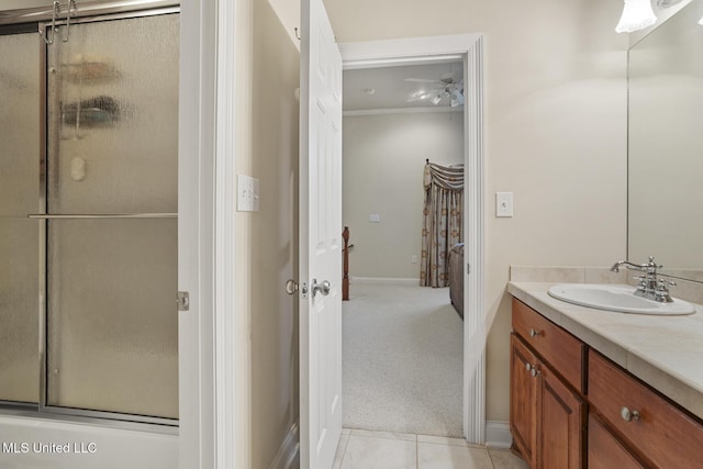 bathroom featuring vanity, tile patterned flooring, and a shower with door