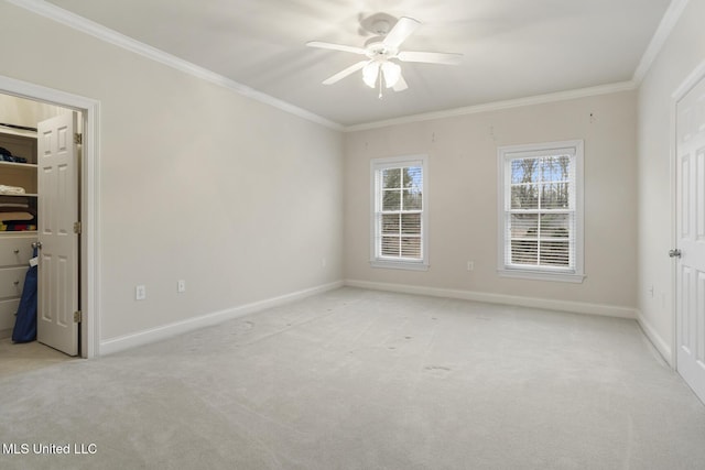 unfurnished bedroom featuring crown molding, a walk in closet, and light colored carpet