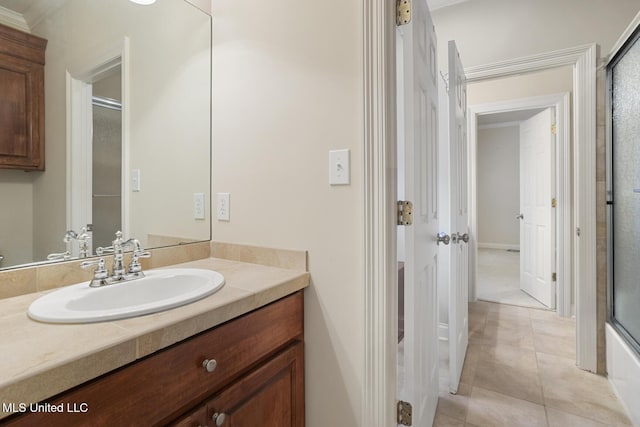 bathroom featuring tile patterned floors, vanity, and combined bath / shower with glass door