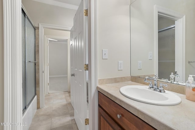 bathroom with enclosed tub / shower combo, vanity, and tile patterned flooring