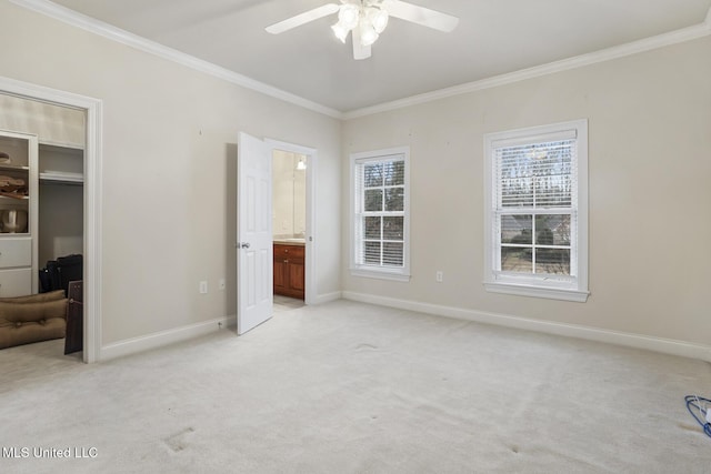 unfurnished bedroom with crown molding, multiple windows, and light carpet