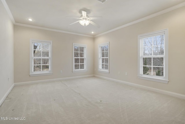 carpeted empty room featuring ornamental molding, a wealth of natural light, and ceiling fan