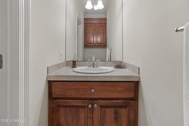 bathroom featuring crown molding and vanity