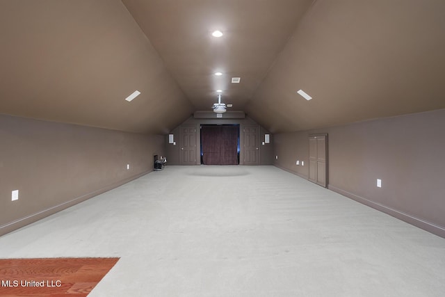 additional living space with lofted ceiling and carpet flooring