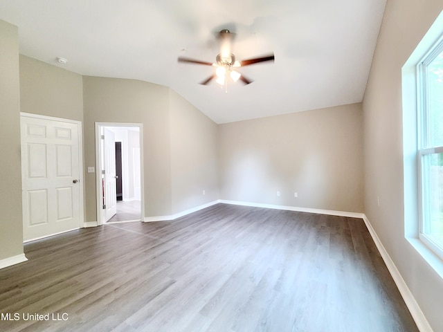 unfurnished room with a ceiling fan, baseboards, vaulted ceiling, and dark wood finished floors