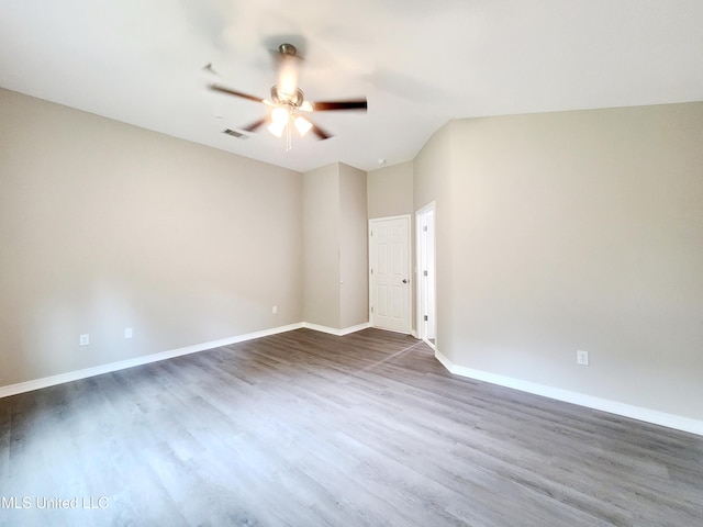 empty room featuring visible vents, baseboards, ceiling fan, and wood finished floors