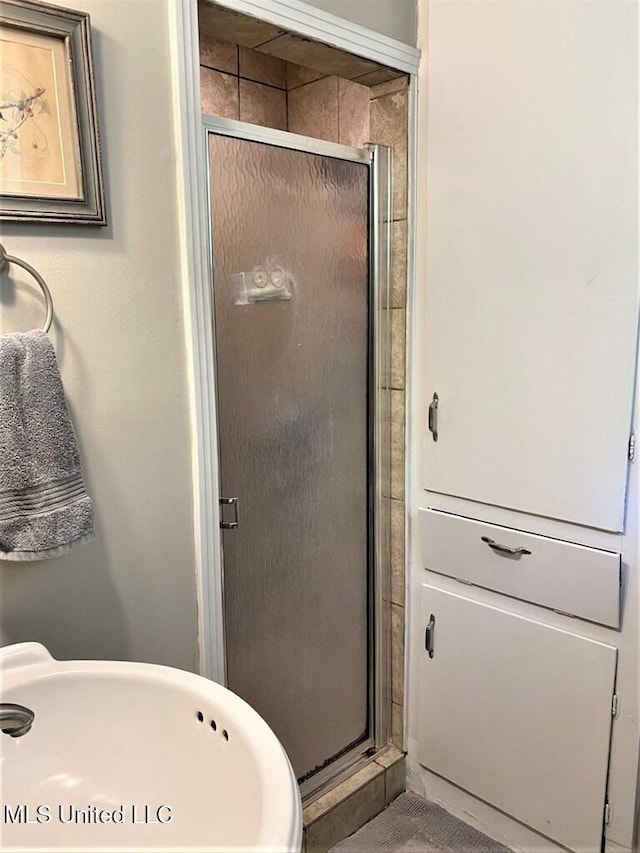 bathroom with sink and an enclosed shower