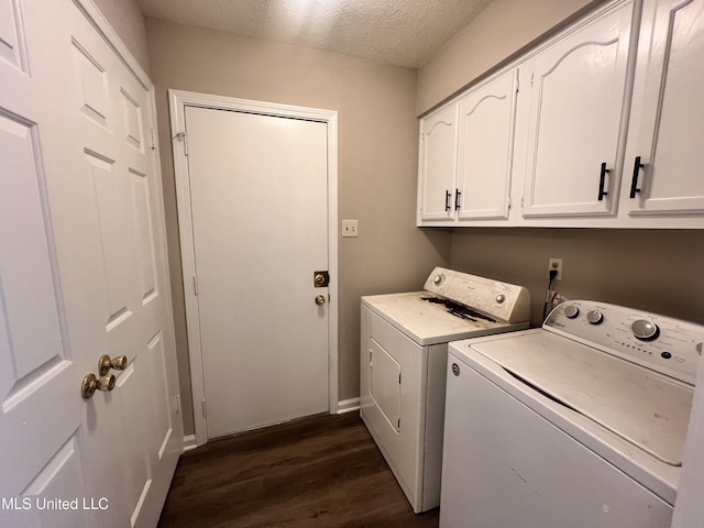 laundry room with dark hardwood / wood-style floors, cabinets, a textured ceiling, and washing machine and clothes dryer