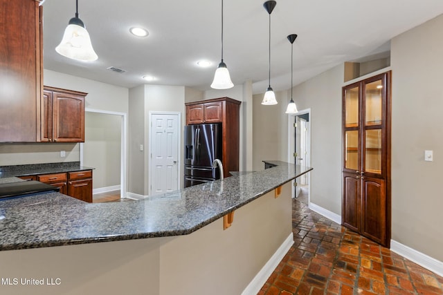 10566 W River Vue, Biloxi, MS 39532 - kitchen with refrigerator with ice dispenser, recessed lighting, a breakfast bar area, decorative light fixtures, and a peninsula