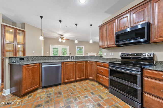 10566 W River Vue, Biloxi, MS 39532 - kitchen with stainless steel appliances, ceiling fan, pendant lighting, a peninsula, and brick flooring