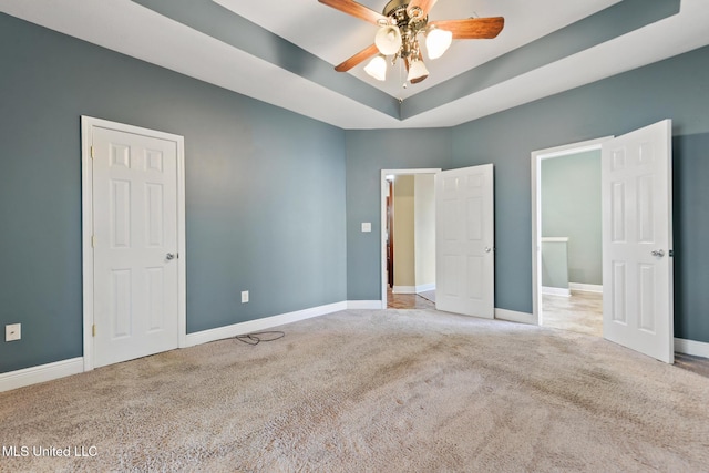 10566 W River Vue, Biloxi, MS 39532 - unfurnished bedroom featuring carpet floors, a tray ceiling, and ceiling fan