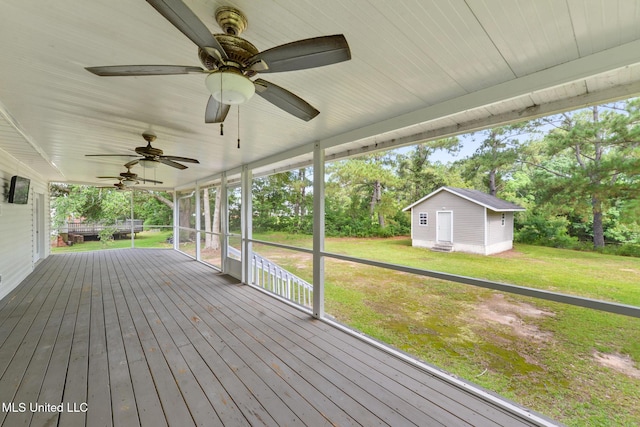 10566 W River Vue, Biloxi, MS 39532 - wooden terrace with a ceiling fan, an outdoor structure, a lawn, and view of wooded area