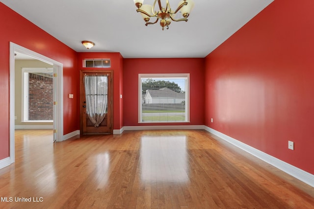 10566 W River Vue, Biloxi, MS 39532 - entrance foyer featuring a chandelier and wood finished floors