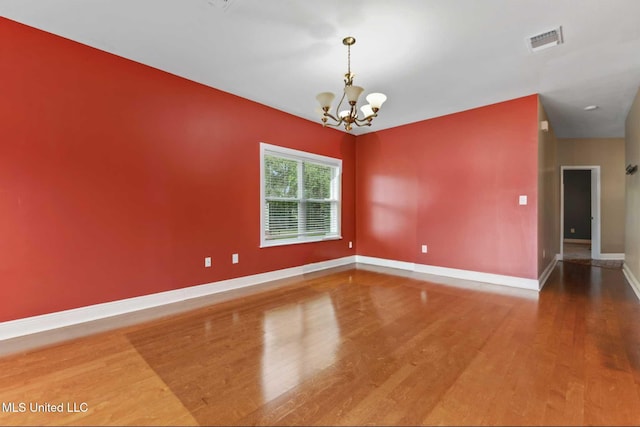 10566 W River Vue, Biloxi, MS 39532 - spare room featuring wood finished floors and a chandelier
