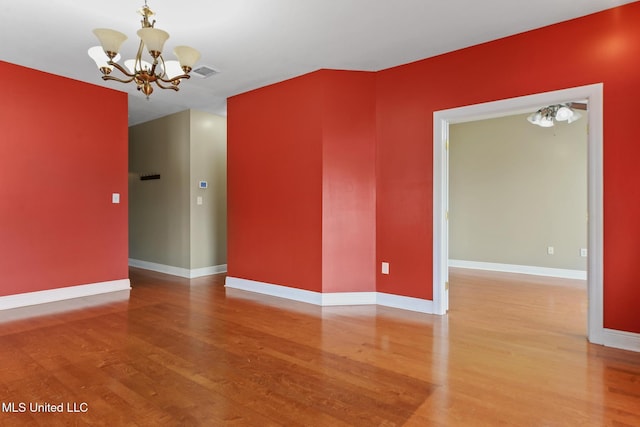 10566 W River Vue, Biloxi, MS 39532 - unfurnished room featuring a chandelier and wood finished floors