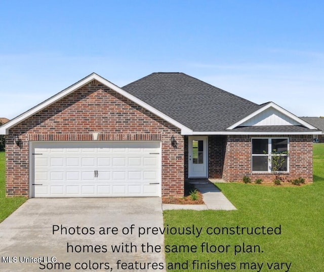 view of front of property with a front yard and a garage