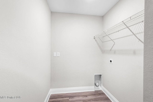 laundry area with hardwood / wood-style flooring and hookup for an electric dryer