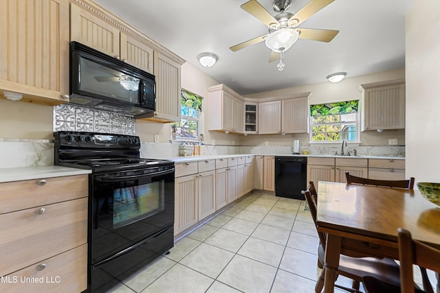 211 Demontluzin Ave, Bay Saint Louis, MS 39520 - kitchen featuring black appliances, a sink, light countertops, and a ceiling fan