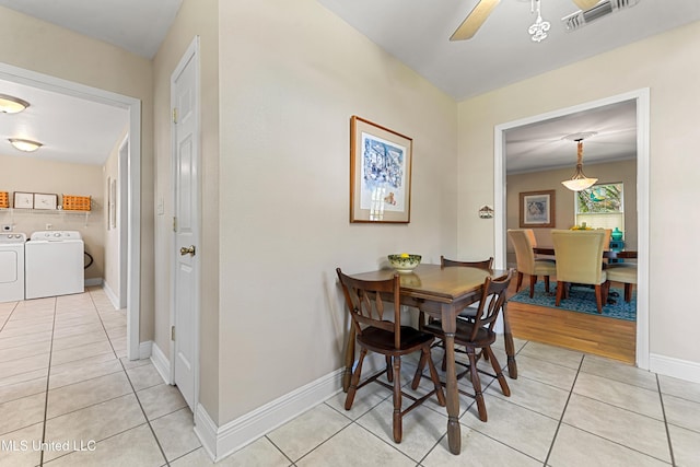 211 Demontluzin Ave, Bay Saint Louis, MS 39520 - dining space featuring independent washer and dryer, light tile patterned floors, a ceiling fan, and baseboards