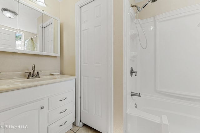 211 Demontluzin Ave, Bay Saint Louis, MS 39520 - bathroom featuring bathing tub / shower combination, vanity, and tile patterned flooring