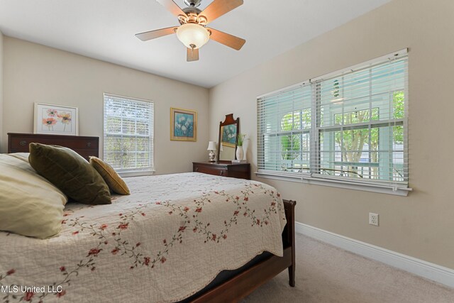 211 Demontluzin Ave, Bay Saint Louis, MS 39520 - carpeted bedroom featuring multiple windows, baseboards, and ceiling fan