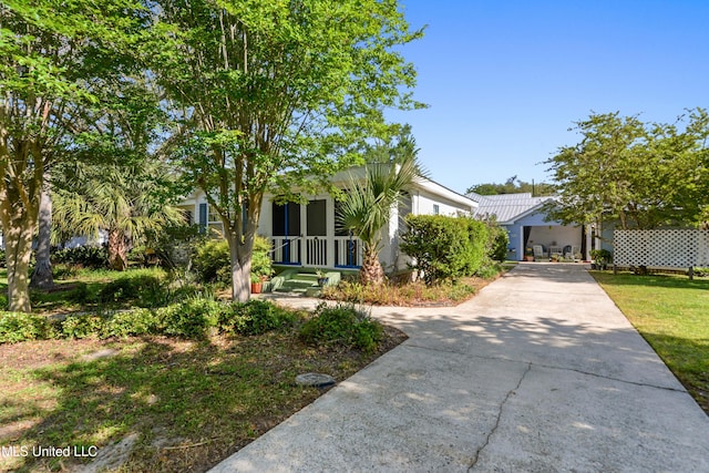 211 Demontluzin Ave, Bay Saint Louis, MS 39520 - obstructed view of property with driveway and stucco siding