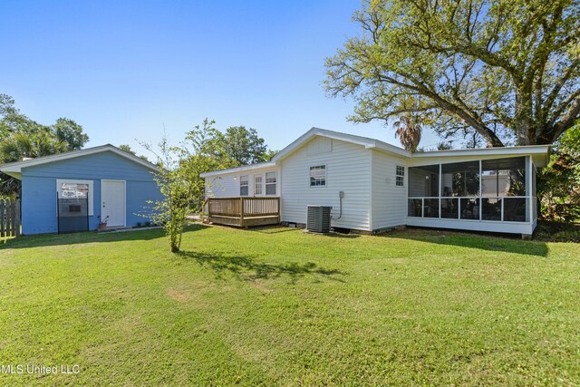 211 Demontluzin Ave, Bay Saint Louis, MS 39520 - back of house with a sunroom, a lawn, a wooden deck, and central AC