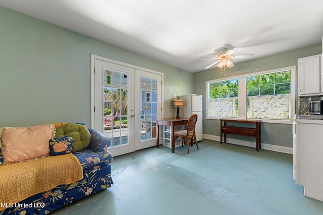 211 Demontluzin Ave, Bay Saint Louis, MS 39520 - living area with french doors, concrete flooring, baseboards, and a ceiling fan