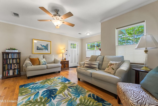 211 Demontluzin Ave, Bay Saint Louis, MS 39520 - living area featuring a ceiling fan, crown molding, wood finished floors, and baseboards