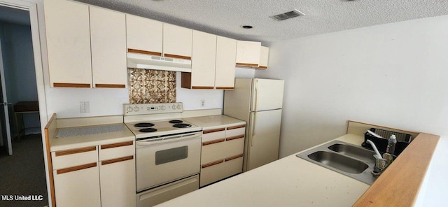 kitchen featuring white cabinetry, sink, white appliances, and a textured ceiling