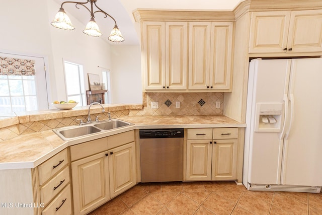kitchen with dishwasher, white refrigerator with ice dispenser, light countertops, a sink, and light tile patterned floors