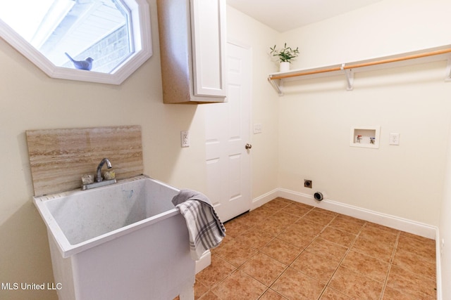 washroom featuring baseboards, electric dryer hookup, a sink, washer hookup, and light tile patterned floors
