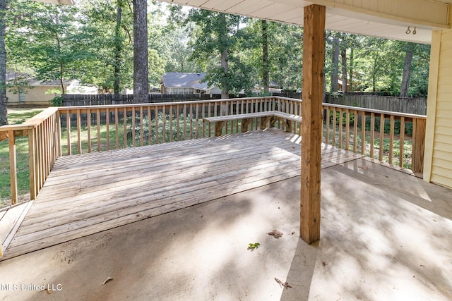 wooden terrace with a fenced backyard