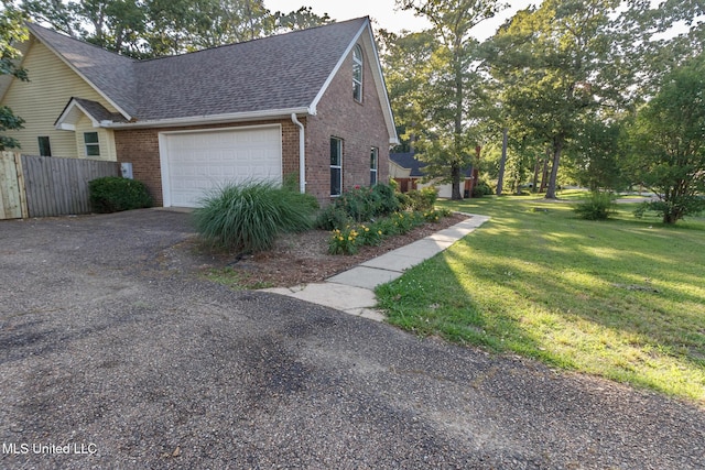 view of side of property with brick siding, an attached garage, fence, and a shingled roof