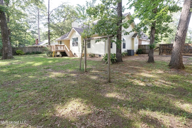 view of yard featuring a fenced backyard, stairway, a deck, and central AC unit