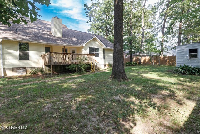 view of yard featuring fence and a deck